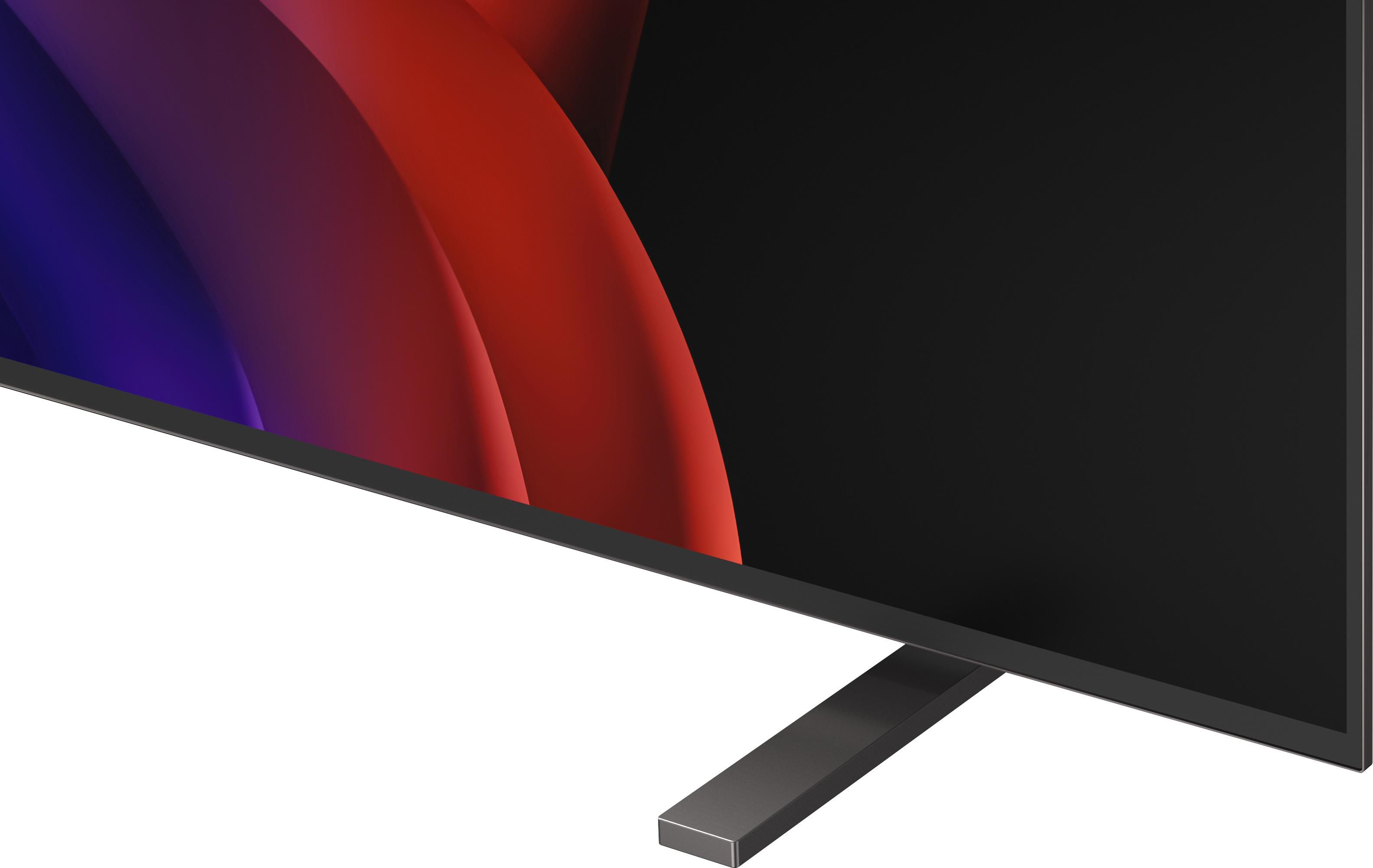 Nahaufnahme eines Fernsehers mit abstraktem Muster in Rot und Blau auf dem Bildschirm.
