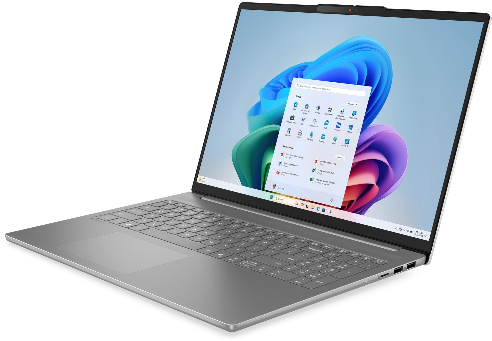 Ezüst laptop Windows 11 indítómenüvel és színes háttérgrafikával.