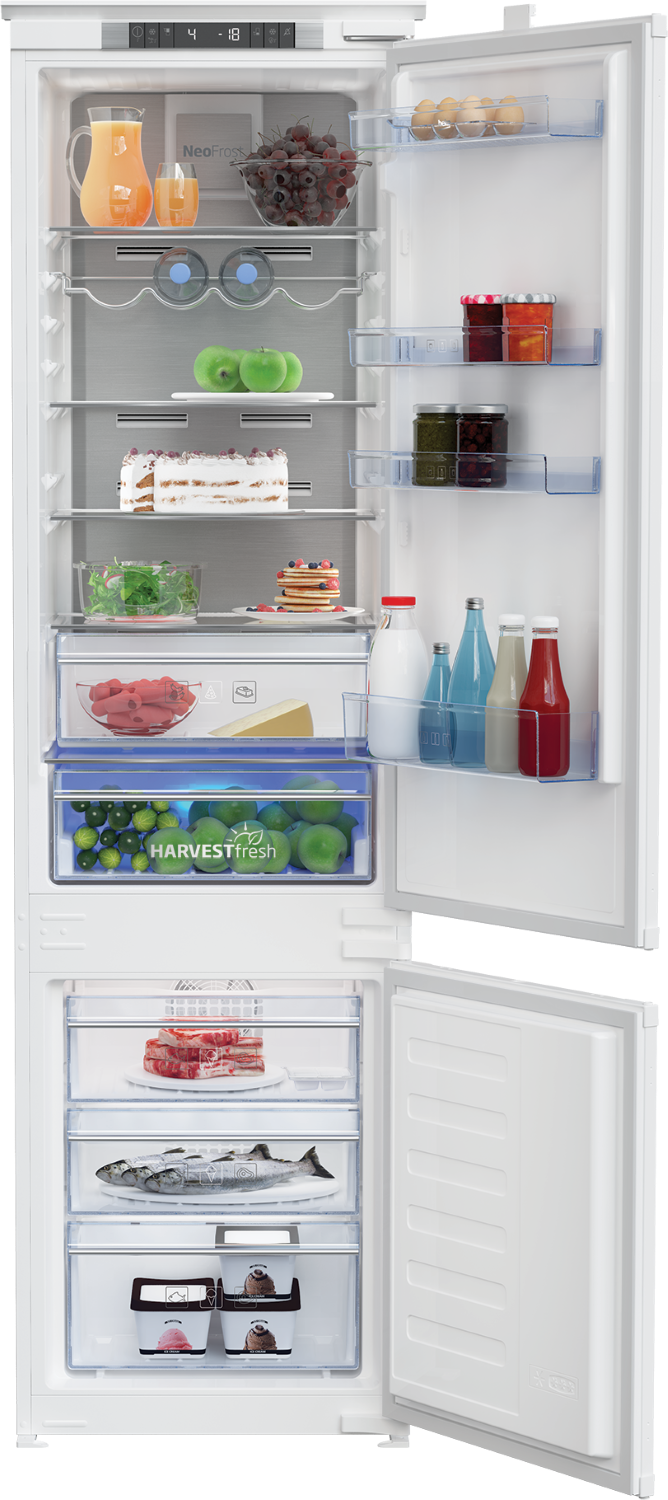 Un refrigerador abierto con alimentos como fruta, pastel, pescado, helado y bebidas.