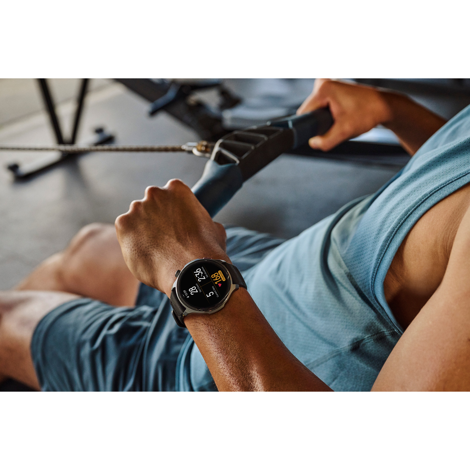 Uomo usa macchina a cavi, indossa smartwatch con dati fitness.