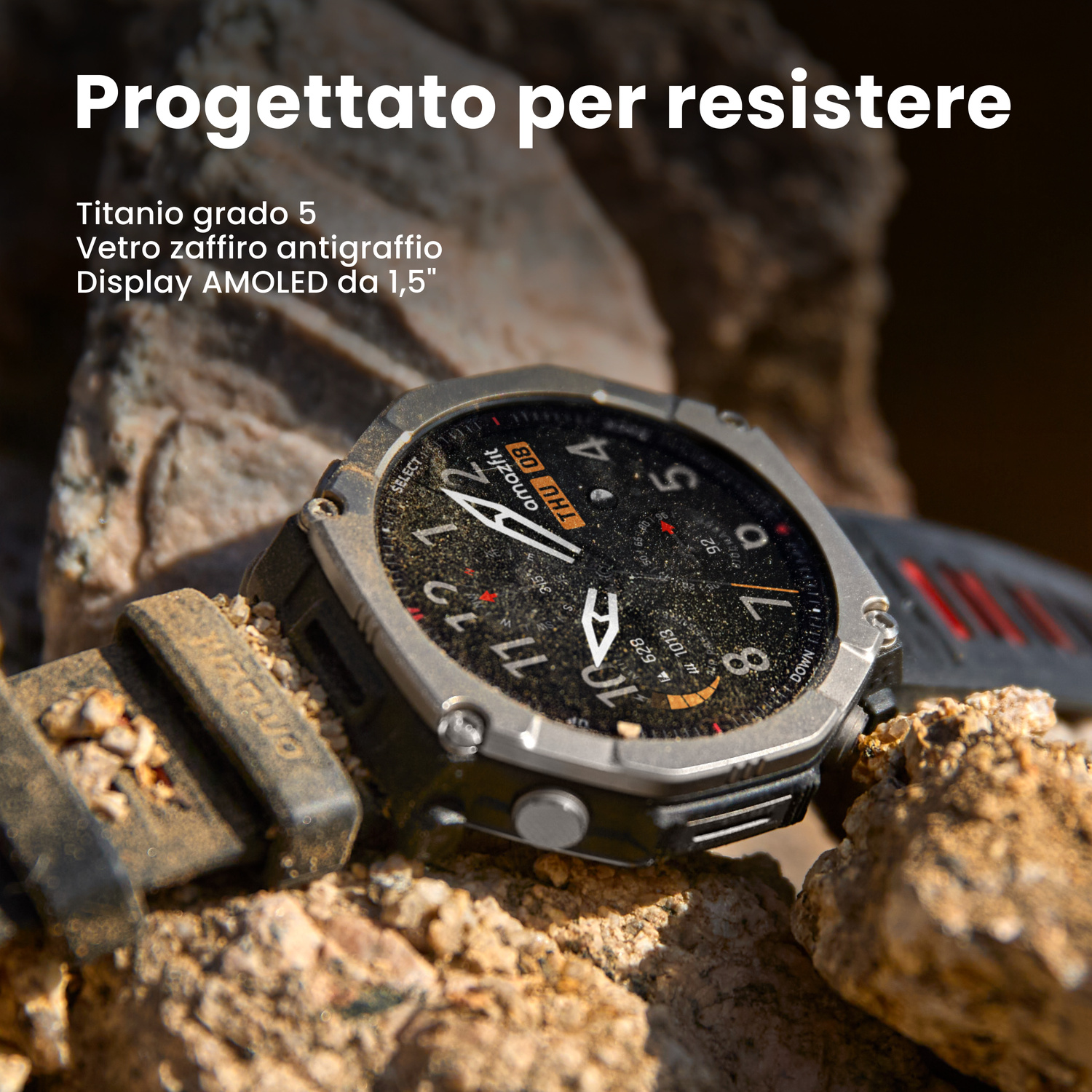 Un robusto smartwatch con cinturino nero e rosso poggia sulle rocce.