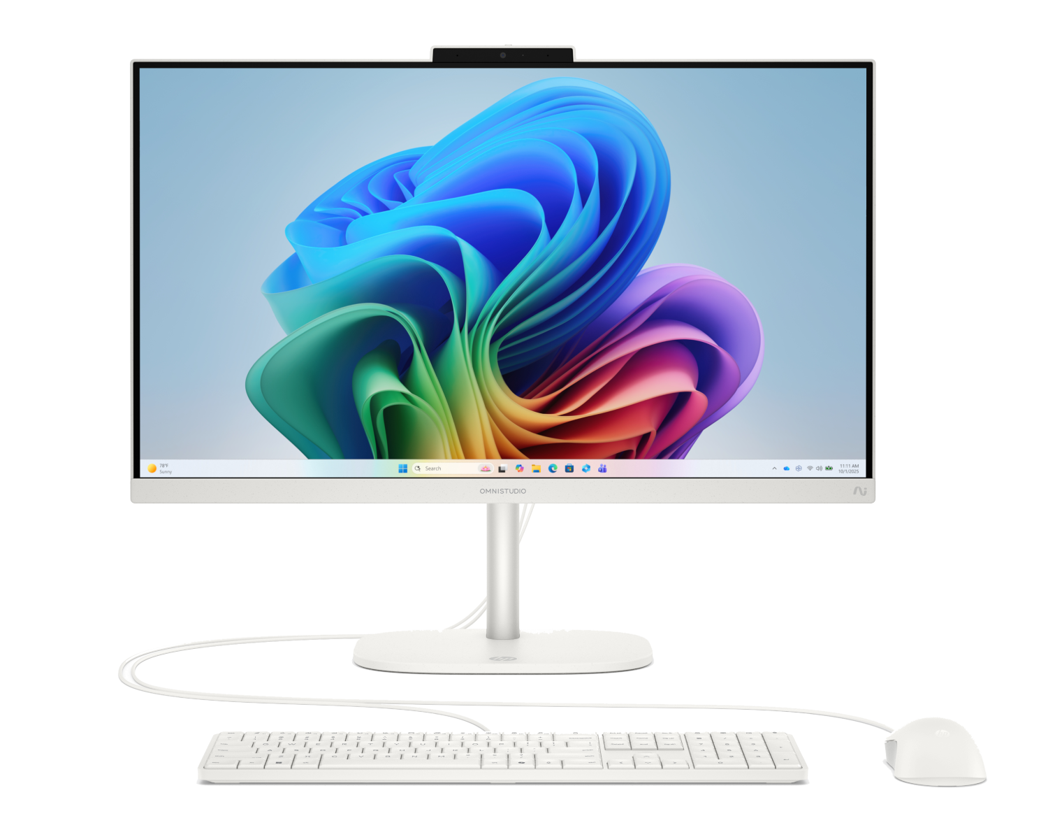 Un ordenador todo en uno blanco con teclado y ratón frente a un fondo colorido.