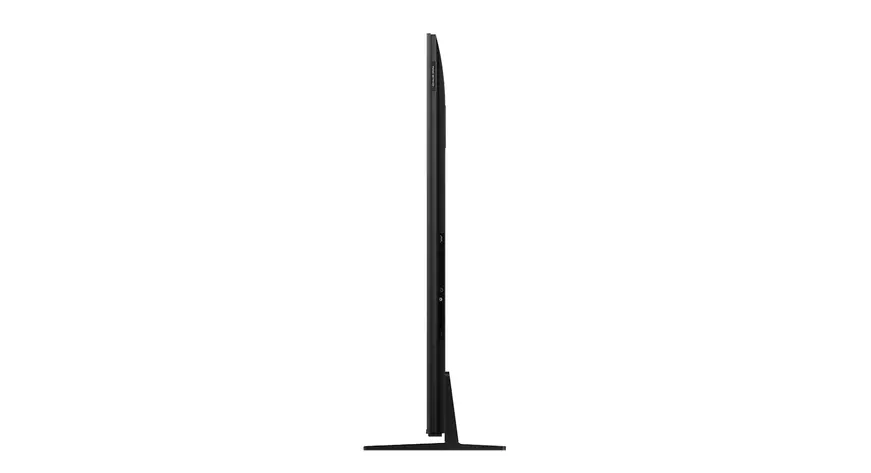 Televisor negro sobre un soporte estrecho, visto de lado.