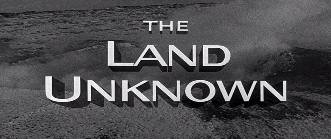 Der Titel "The Land Unknown" ist in weißer Schrift auf einem dunklen, rauen Hintergrund.