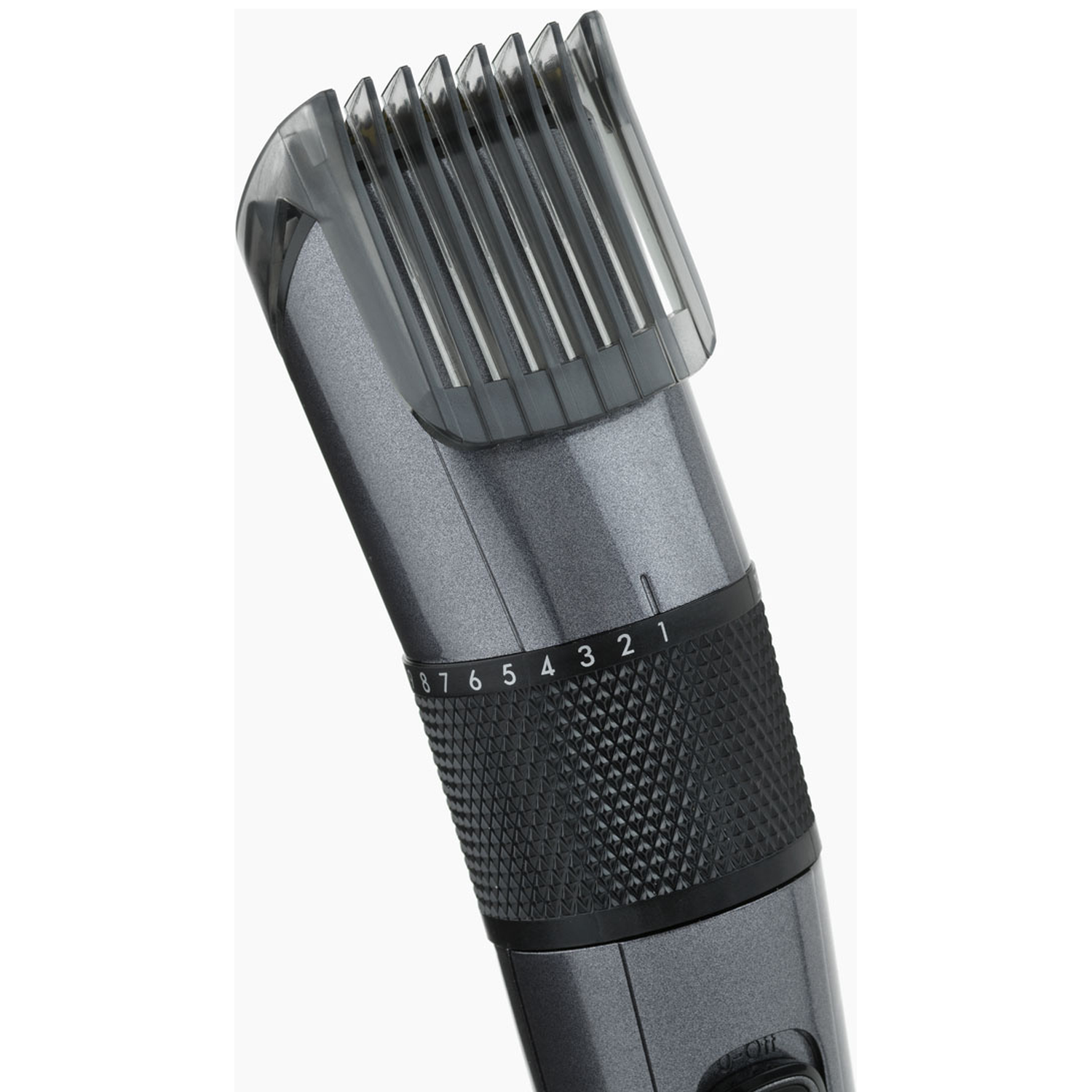 Close-up of a gray hair clipper with a transparent guard and numbered dial.