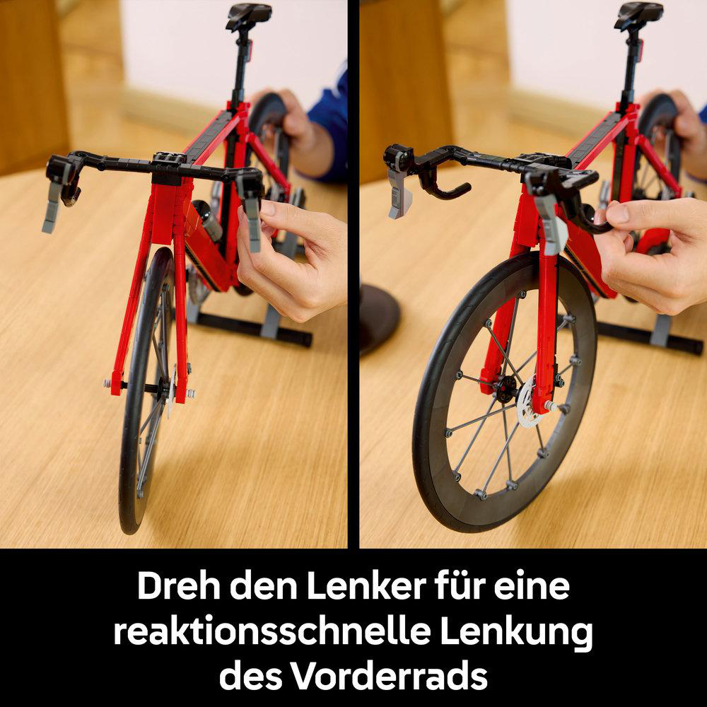 Rotes Lego-Rennrad-Modell mit Händen, die den Lenker bewegen.