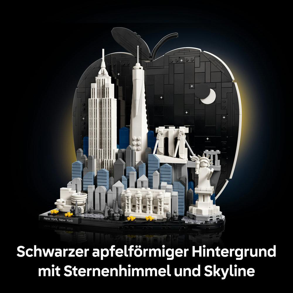 New Yorker Skyline mit Freiheitsstatue vor schwarzem Apfelhintergrund mit Sternen.