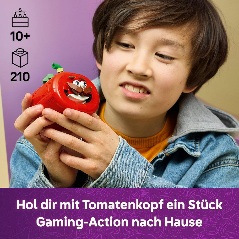 Junge hält eine rote Tomatenfigur mit Augen und einem grünen Stiel. Alter 10+, 210 Teile.