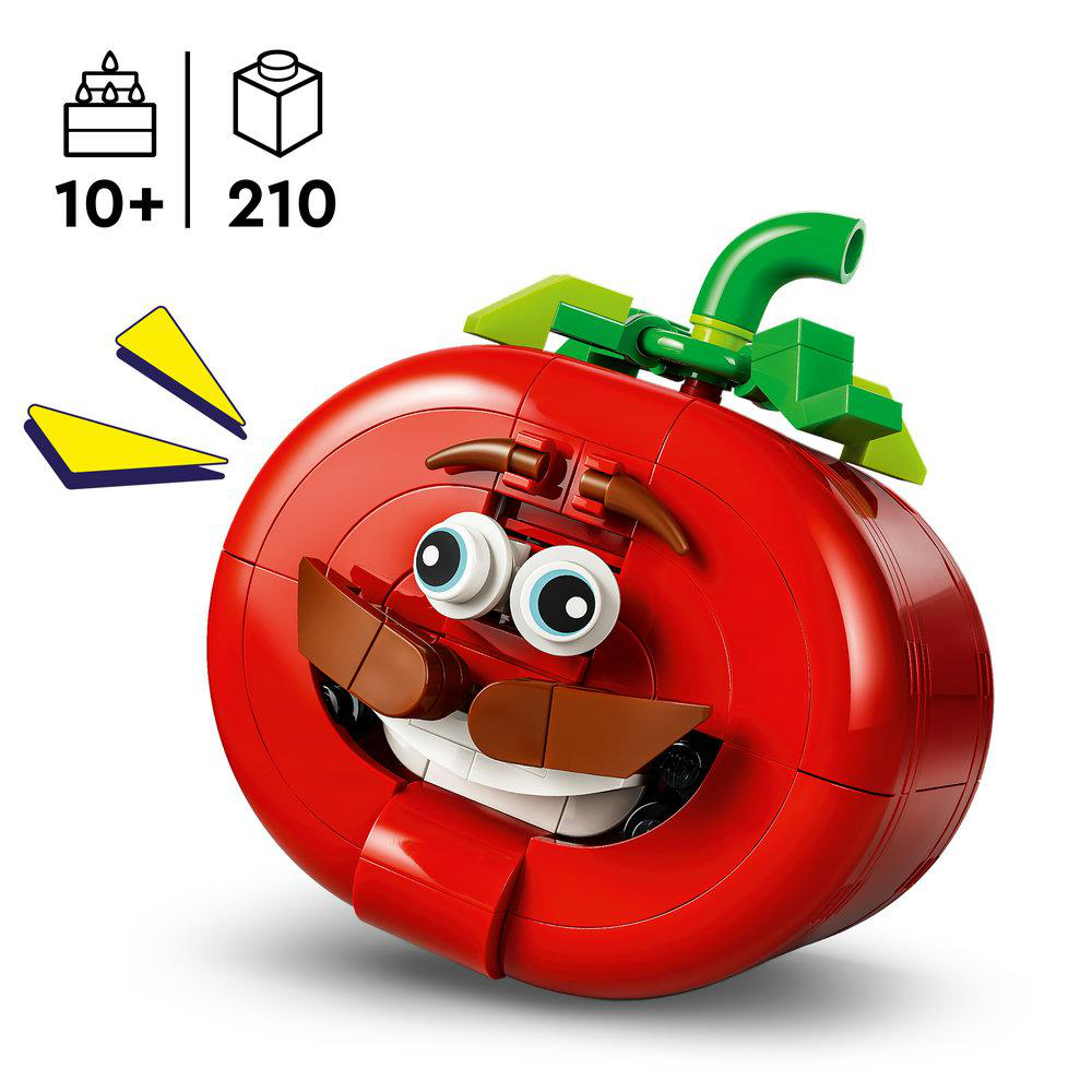 Ein rotes Lego-Tomaten-Gesicht mit Augen, Mund und grünen Blättern.