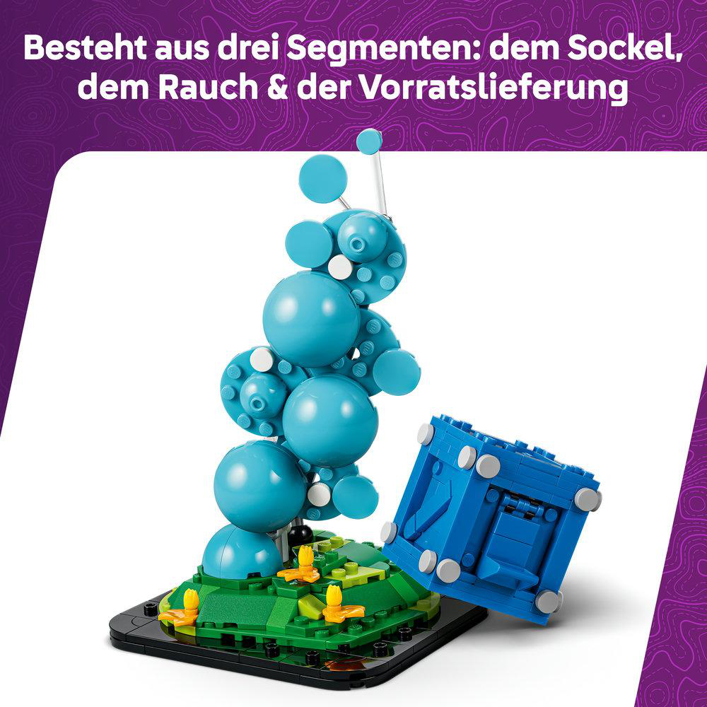 Blauer Würfel und blaue Kugeln auf grüner Basis mit gelben Akzenten.