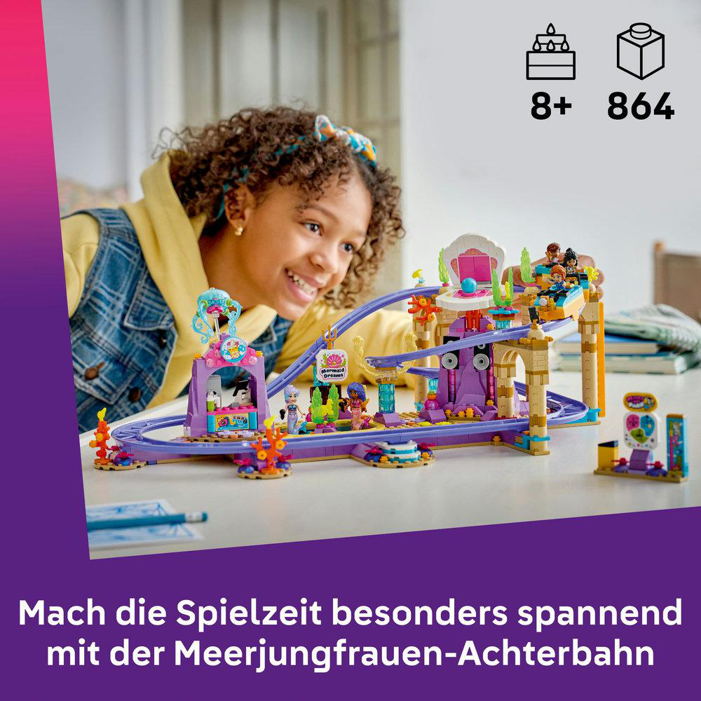 Ein Mädchen blickt auf eine bunte Achterbahn aus Legosteinen mit Figuren.