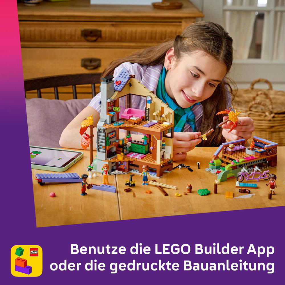 Ein Mädchen baut ein buntes LEGO-Haus mit einer App auf einem Tablet.
