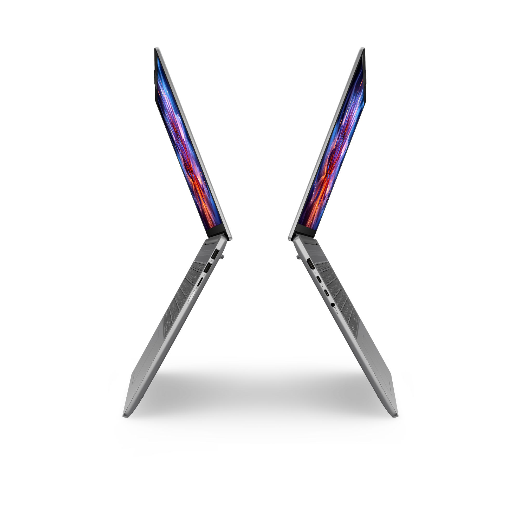Zwei Silverne Laptops mit bunten Bildschirmen auf schwarzem Hintergrund.