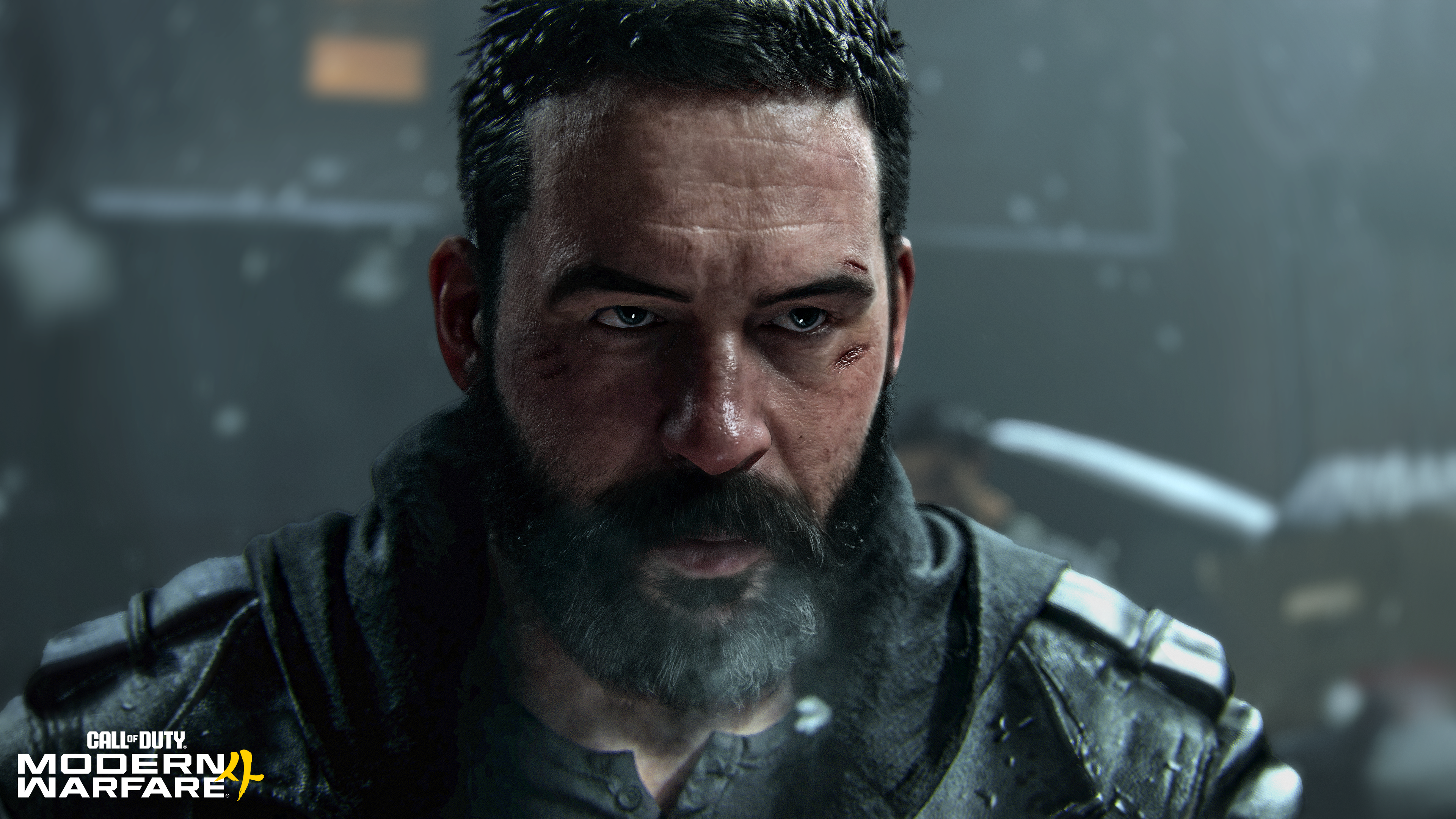 Primer plano de un hombre con barba y cicatrices faciales, vestido con ropa oscura.
