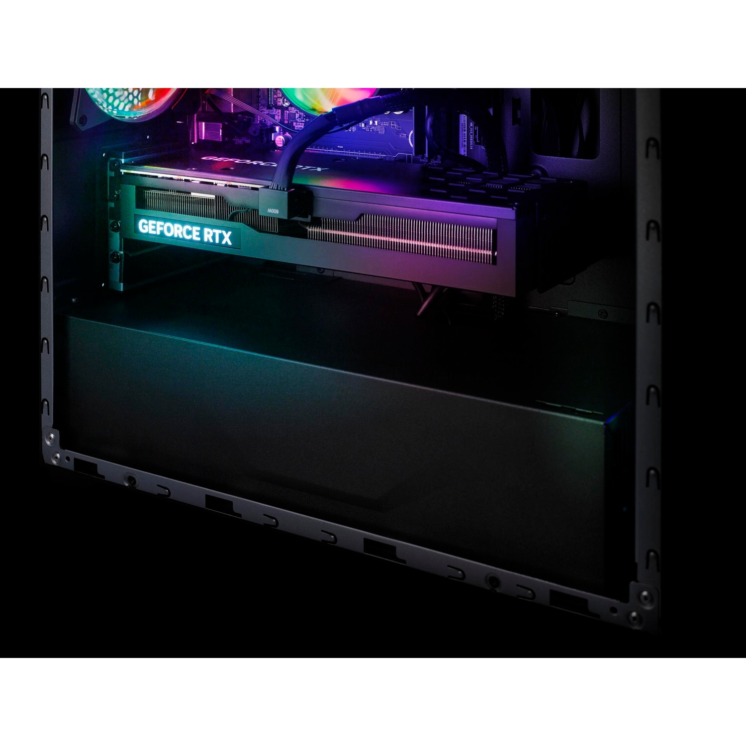 Vue rapprochée à l'intérieur d'un boîtier d'ordinateur de bureau, révélant une carte graphique "GEFORCE RTX" lumineuse avec éclairage RGB coloré.