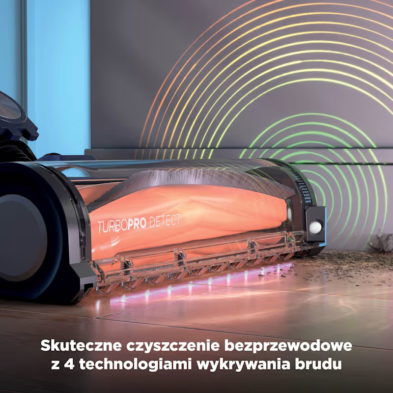 Zbliżenie głowicy odkurzacza z pomarańczową szczotką zbierającą brud.