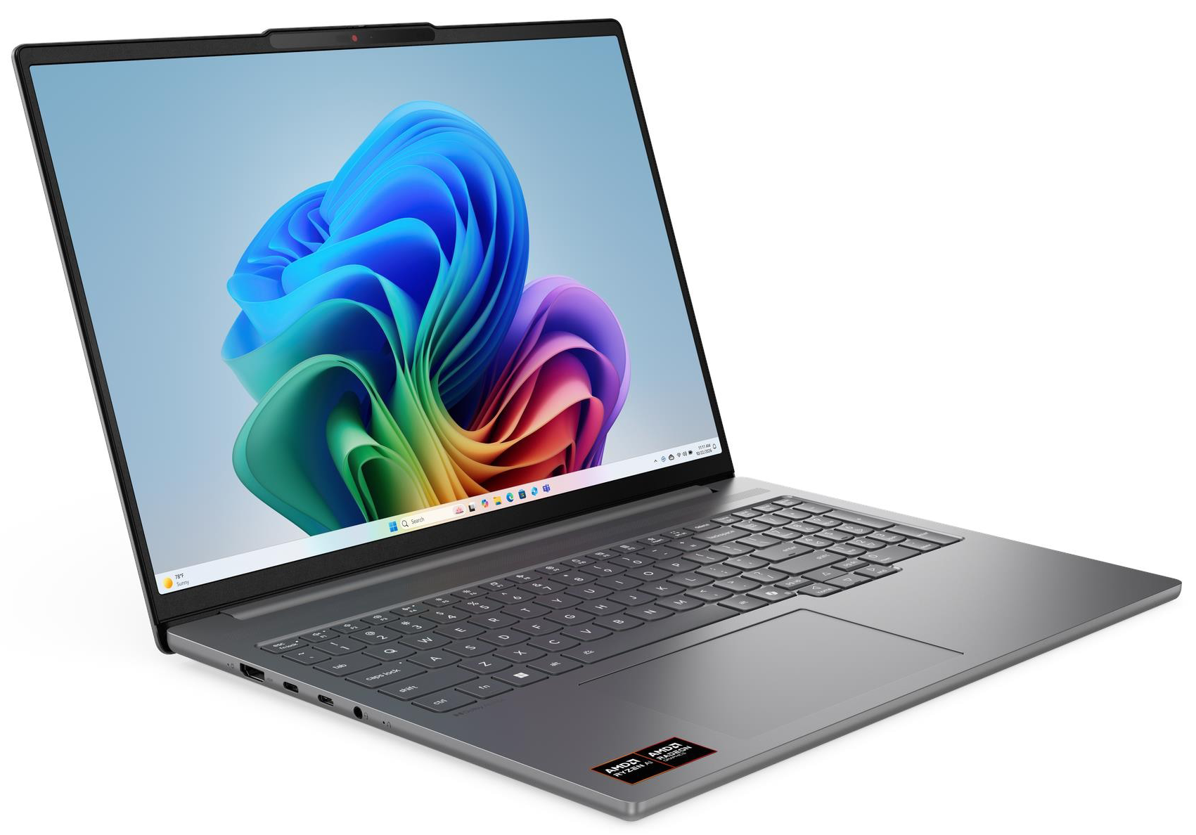 Egy szürke laptop nyitott képernyővel, színes háttérképet jelenít meg.