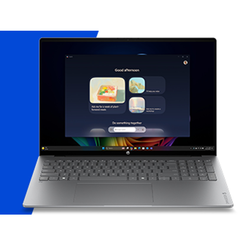 Srebrny laptop wyświetlający powitalną wiadomość i aplikacje na ciemnym ekranie.