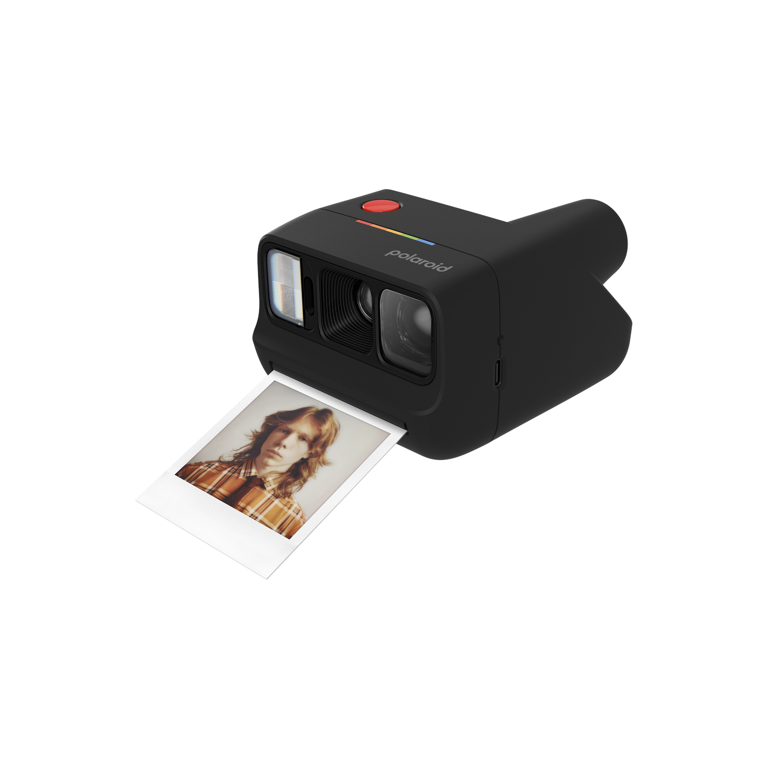 Una cámara Polaroid negra con un botón rojo y una franja colorida, expulsando una foto de una persona con cabello rojizo largo.