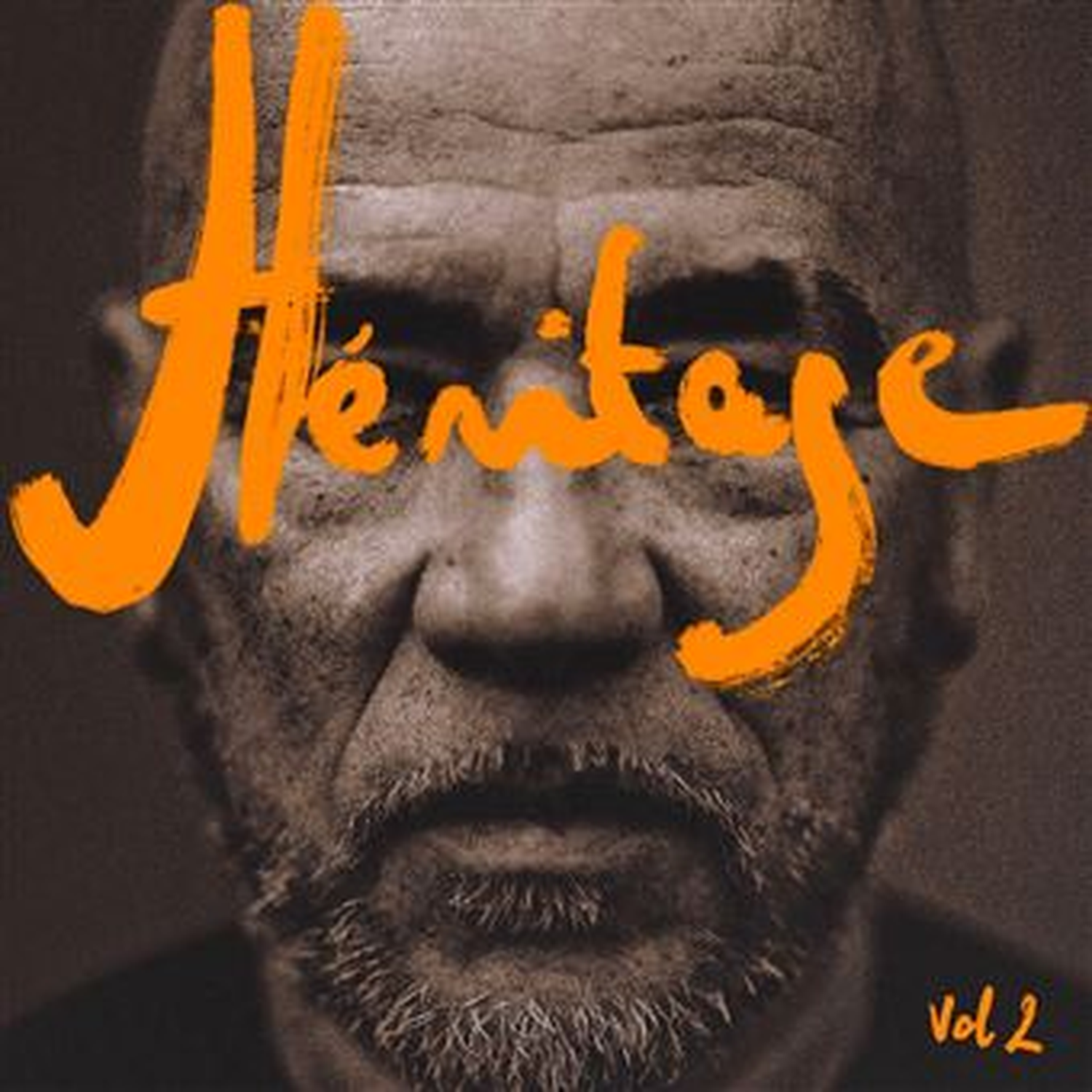 Portret van een man met baard, oranje tekst 'Héritage Vol 2'.
