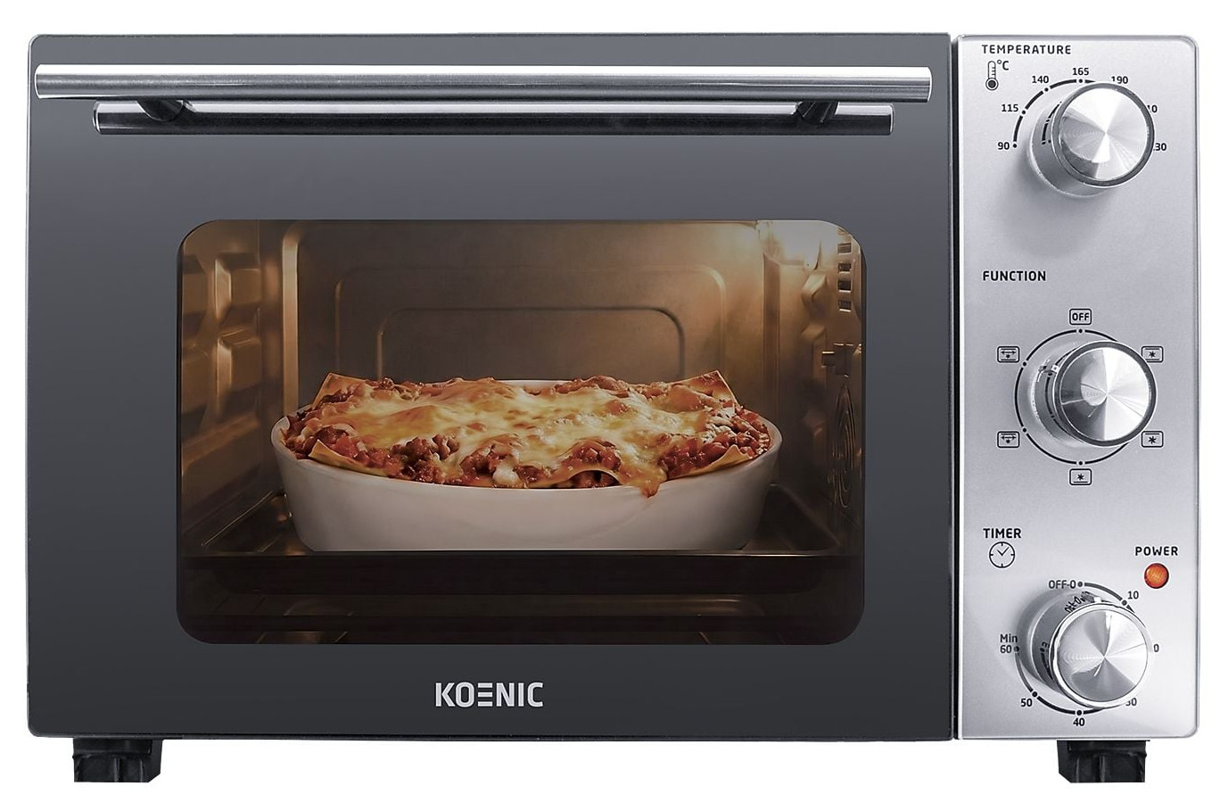 Piekarnik tosterowy Koenic piecze złocistobrązową lasagne w białej formie. Pokrętła po prawej.