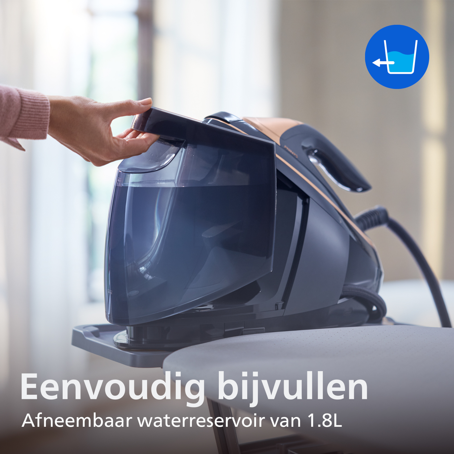 A hand fills the detachable water tank of a steam generator iron.