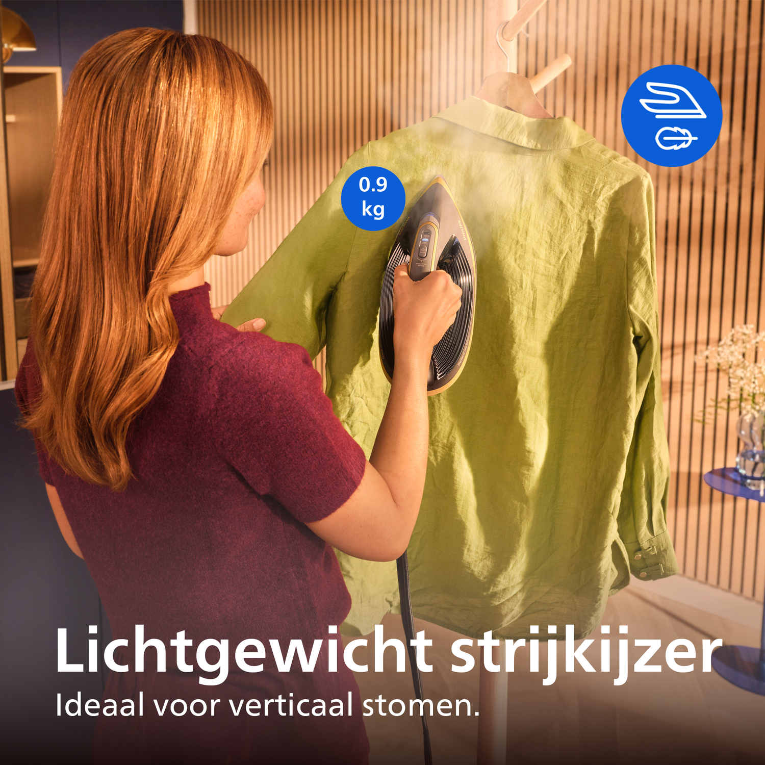 Vrouw stoomt lichtgroen hemd verticaal. Lichtgewicht strijkijzer 0,9 kg.