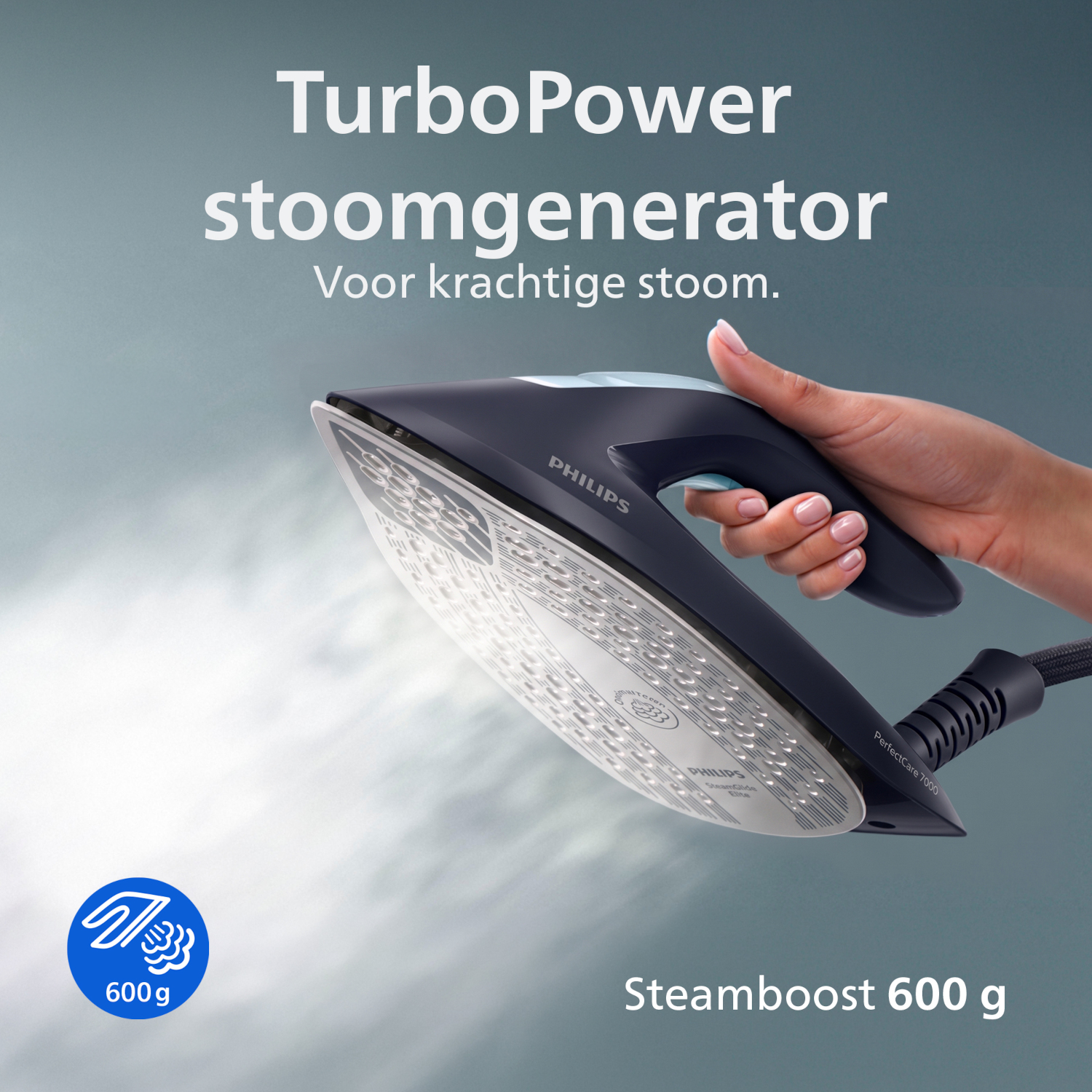 Hand holding a dark blue steam generator iron with steam.