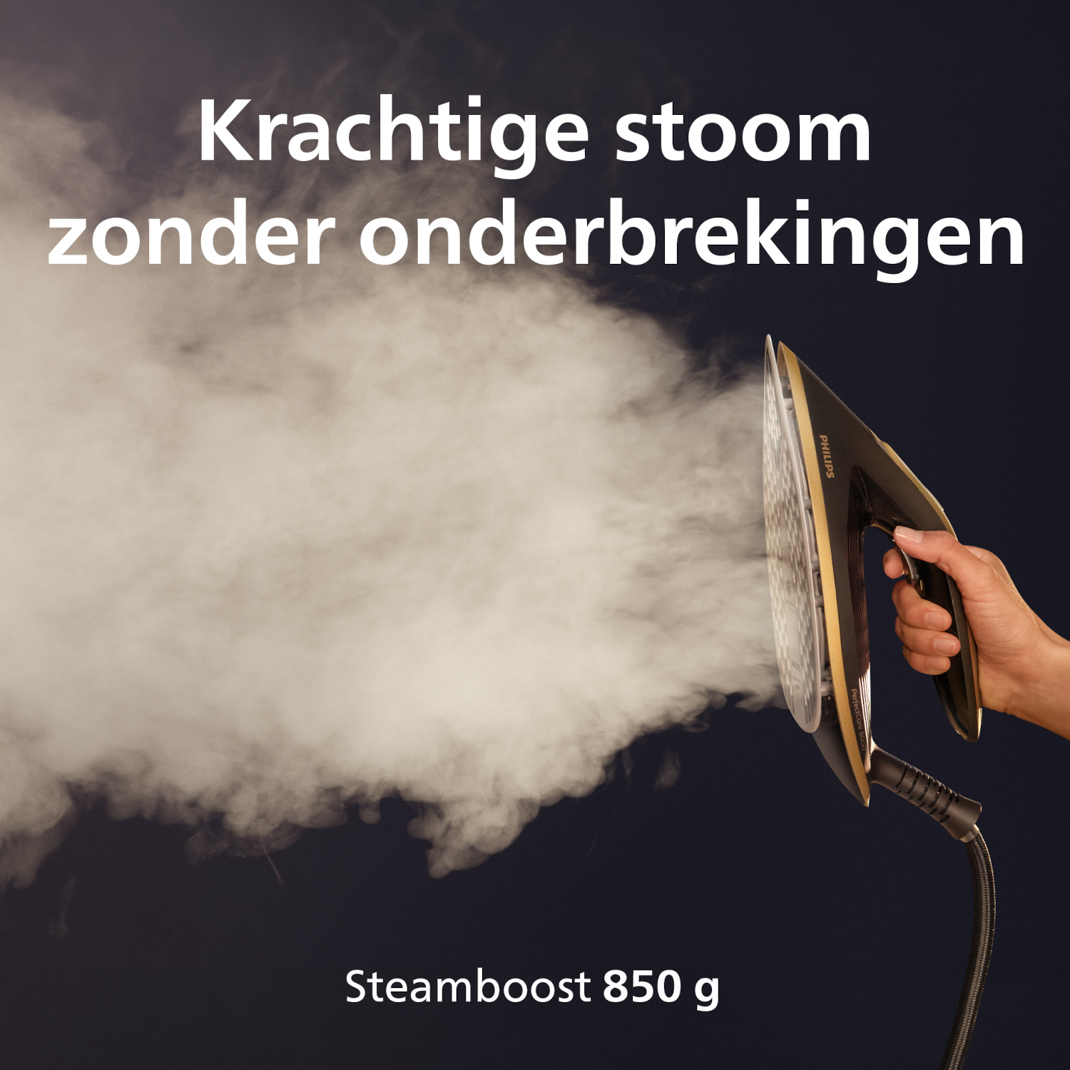A hand holds an iron emitting a powerful stream of steam.