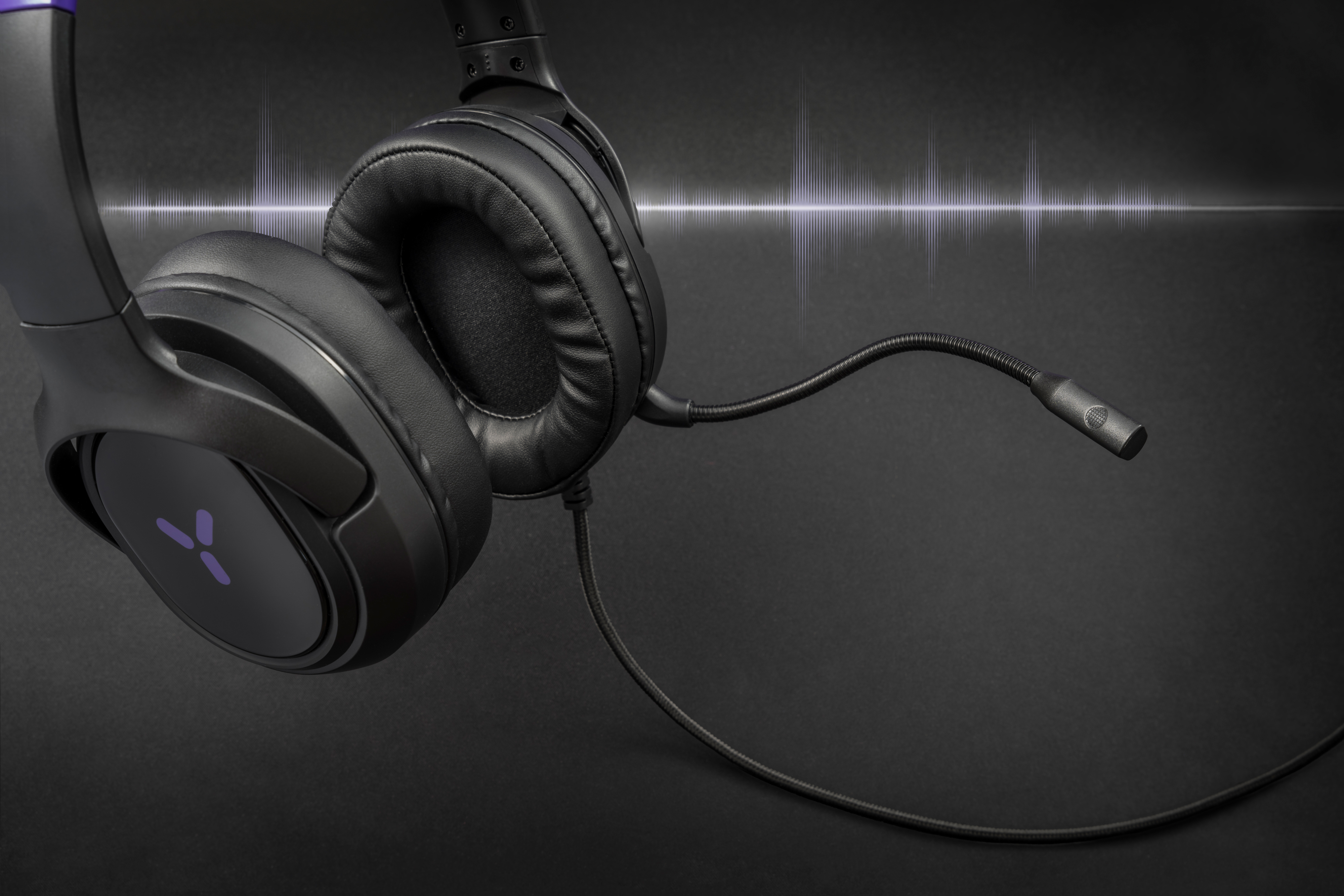 Black headphones with a microphone and purple logo on a dark background with sound waves.