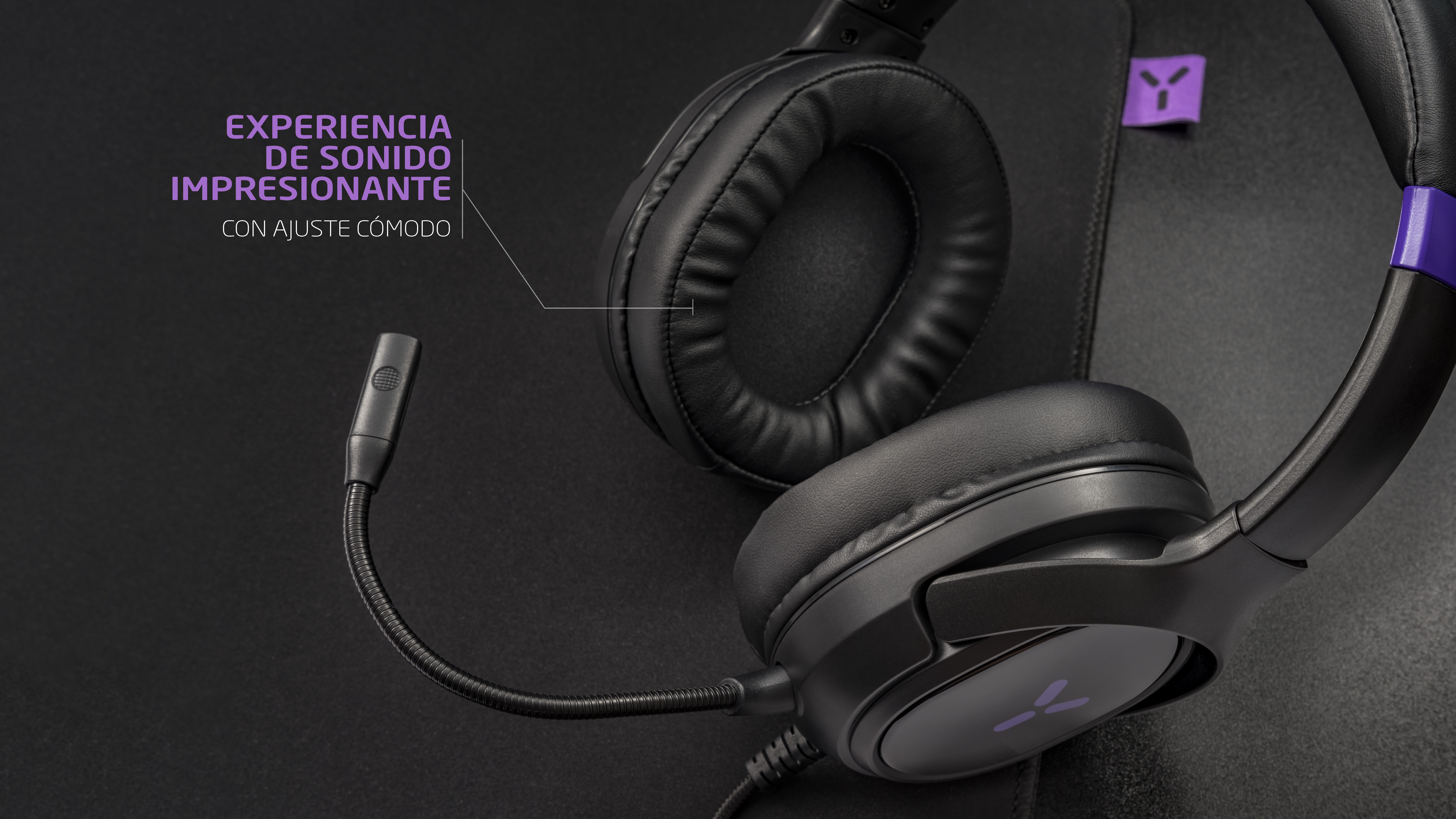 Black gaming headset with microphone and purple accents on a dark background.