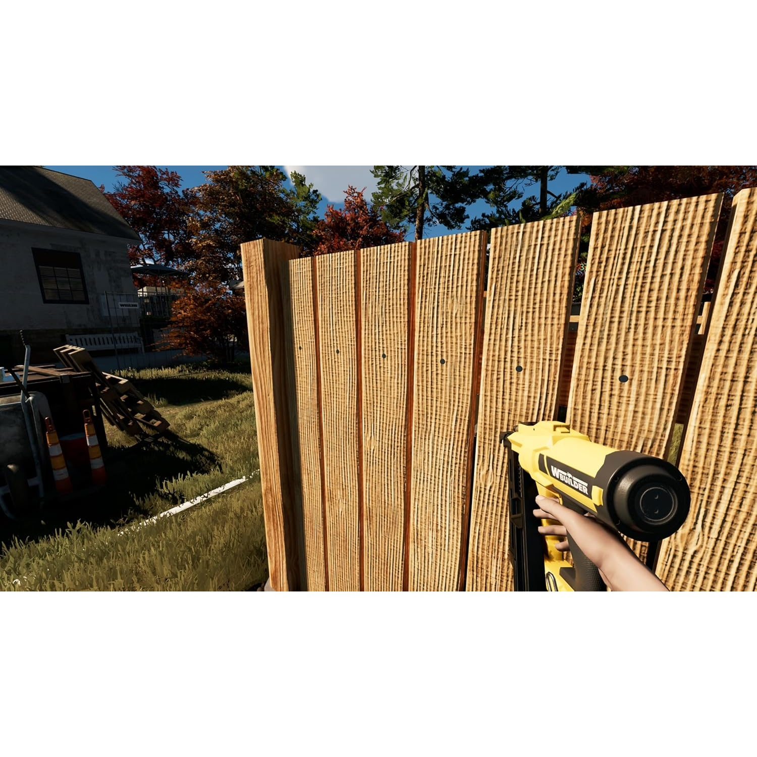 Un pistolet à clous jaune fixe des planches de bois à une nouvelle clôture.