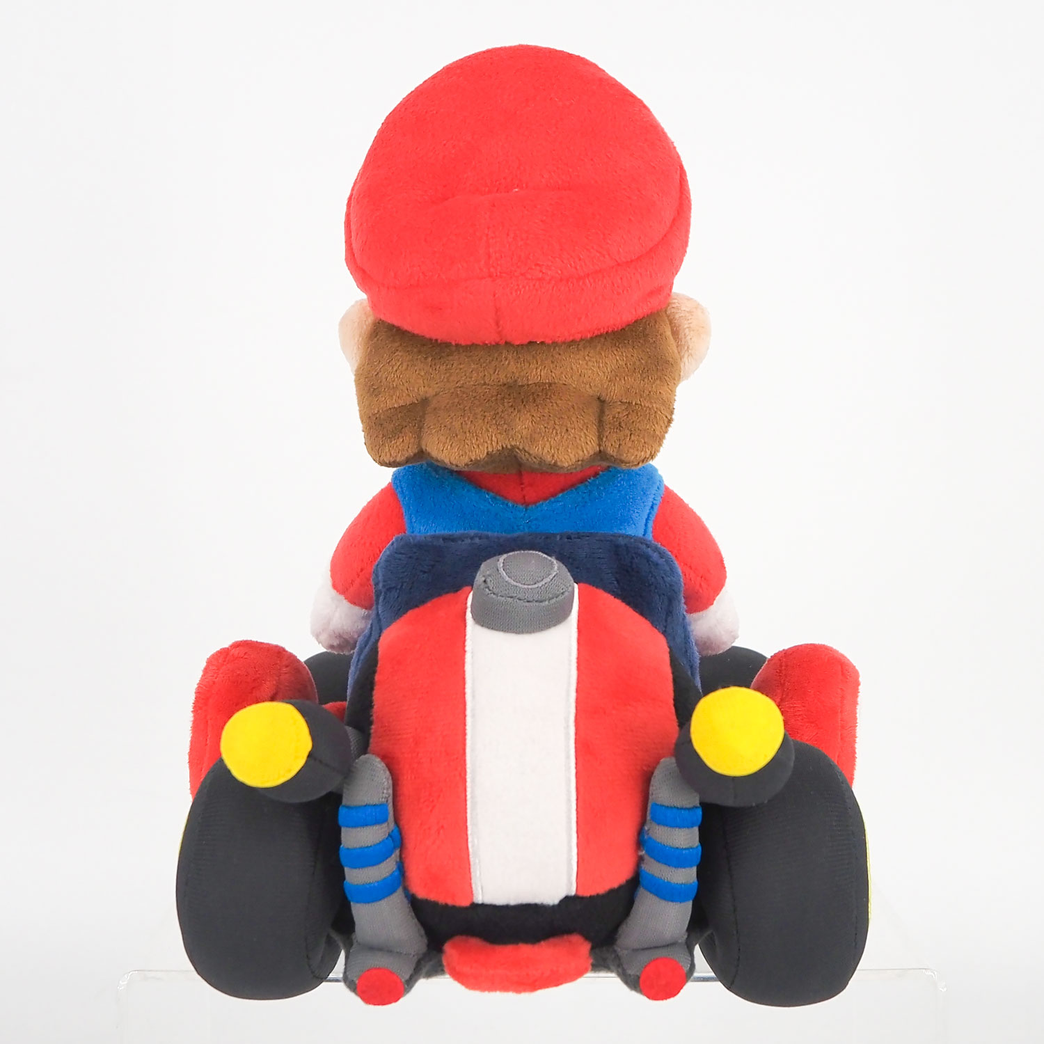 Plüschfigur von Mario in einem roten Go-Kart mit weißen und blauen Akzenten.