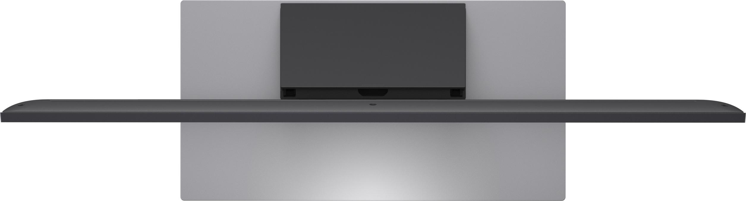 Ein grauer, rechteckiger Monitor mit einem schwarzen Regal davor.