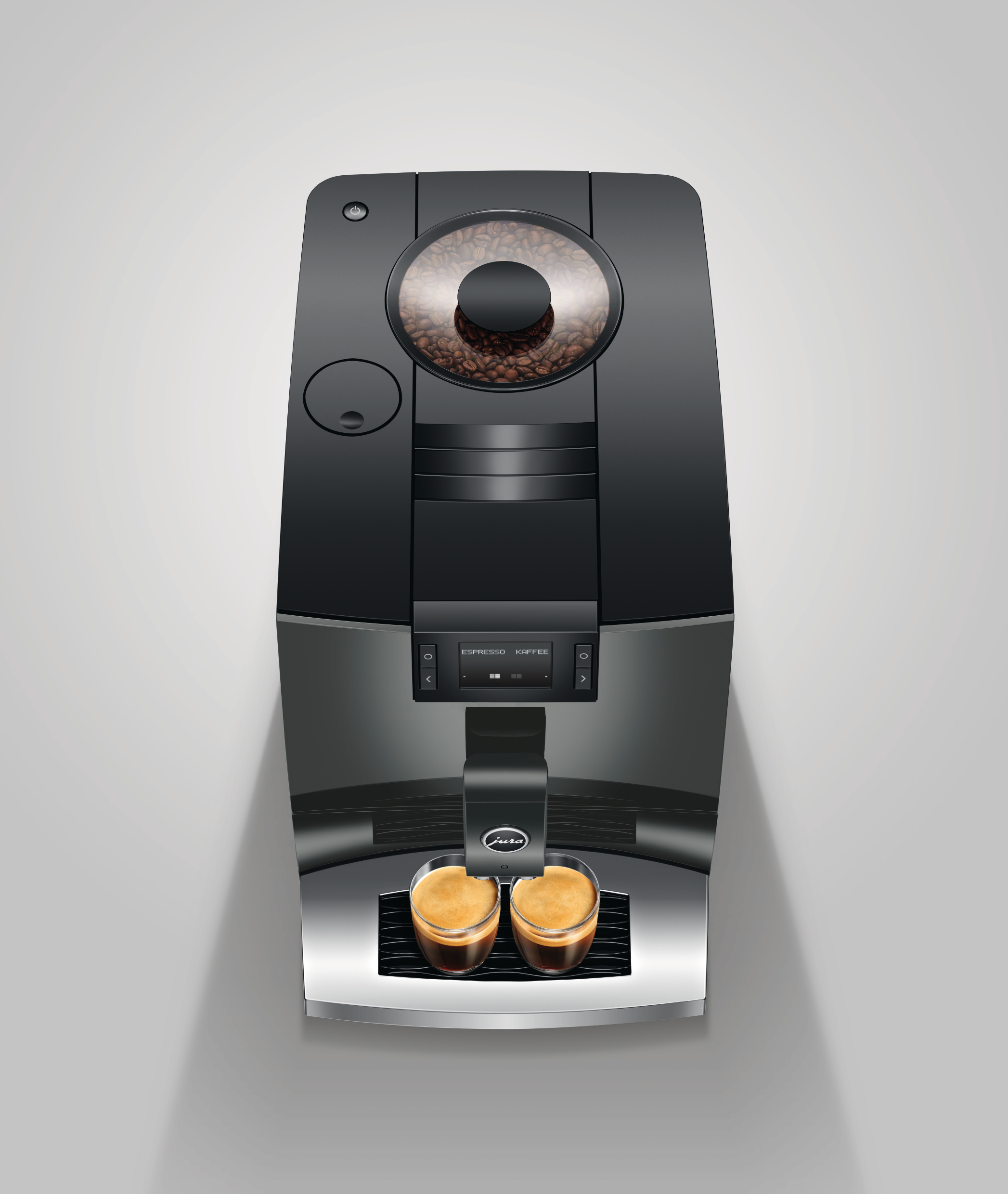 Eine schwarze Kaffeemaschine mit zwei gefüllten Gläsern Espresso.