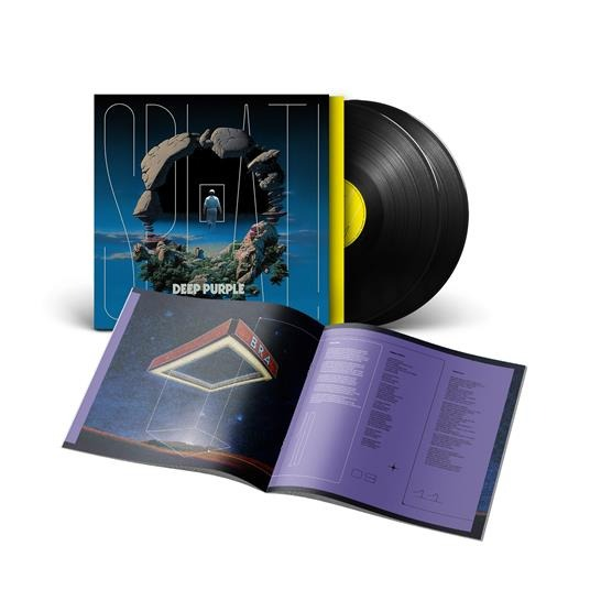 Vinyl record and open book with album cover art showing a man in a window.