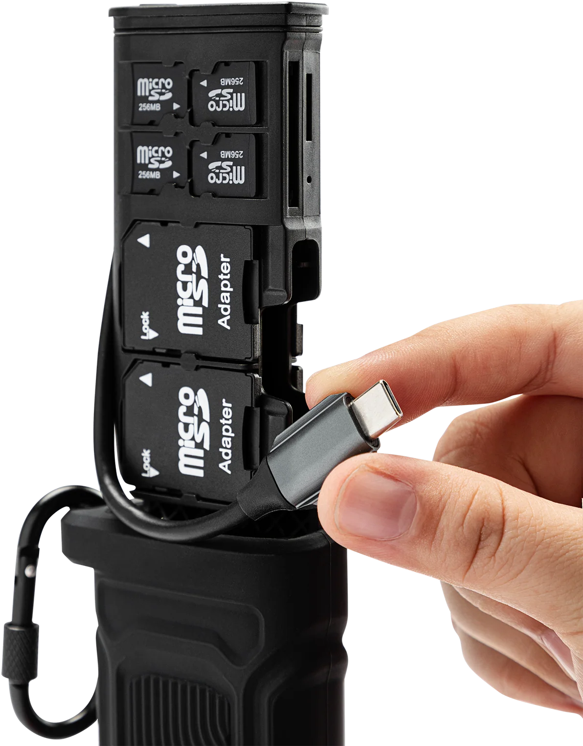 Una persona inserisce un cavo USB-C grigio in un lettore di schede nero con schede MicroSD.