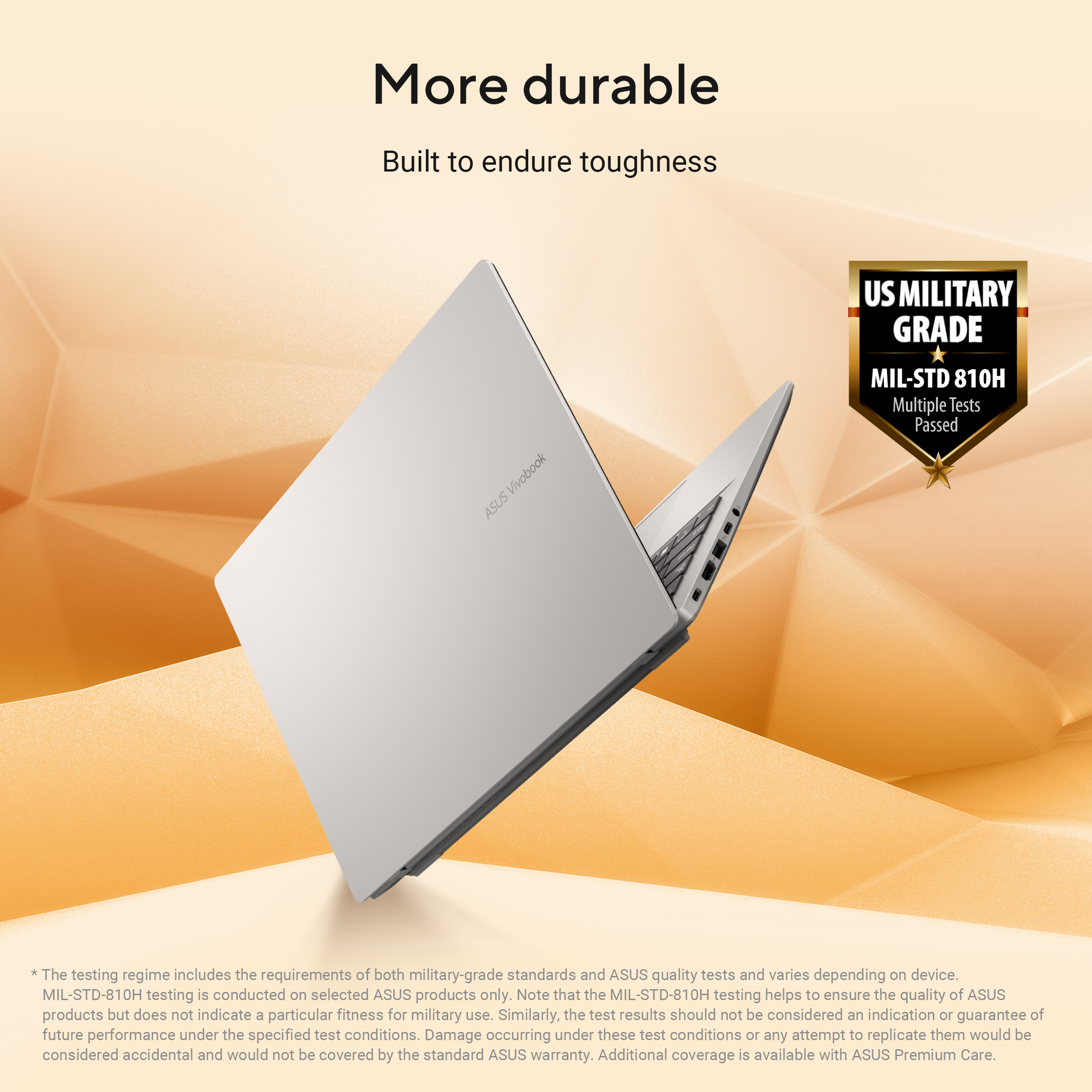 Een zilveren laptop met de tekst "More durable" en een militair graden zegel.
