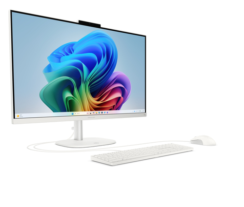 Un ordenador todo en uno blanco con teclado y ratón sobre un fondo colorido.