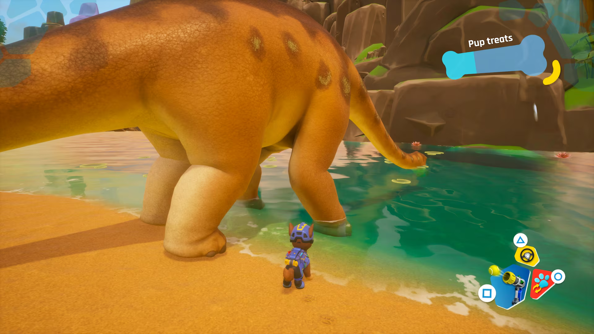 Un chien en uniforme se tient près de l'eau à côté d'un dinosaure. L'interface Pup Treats est visible.