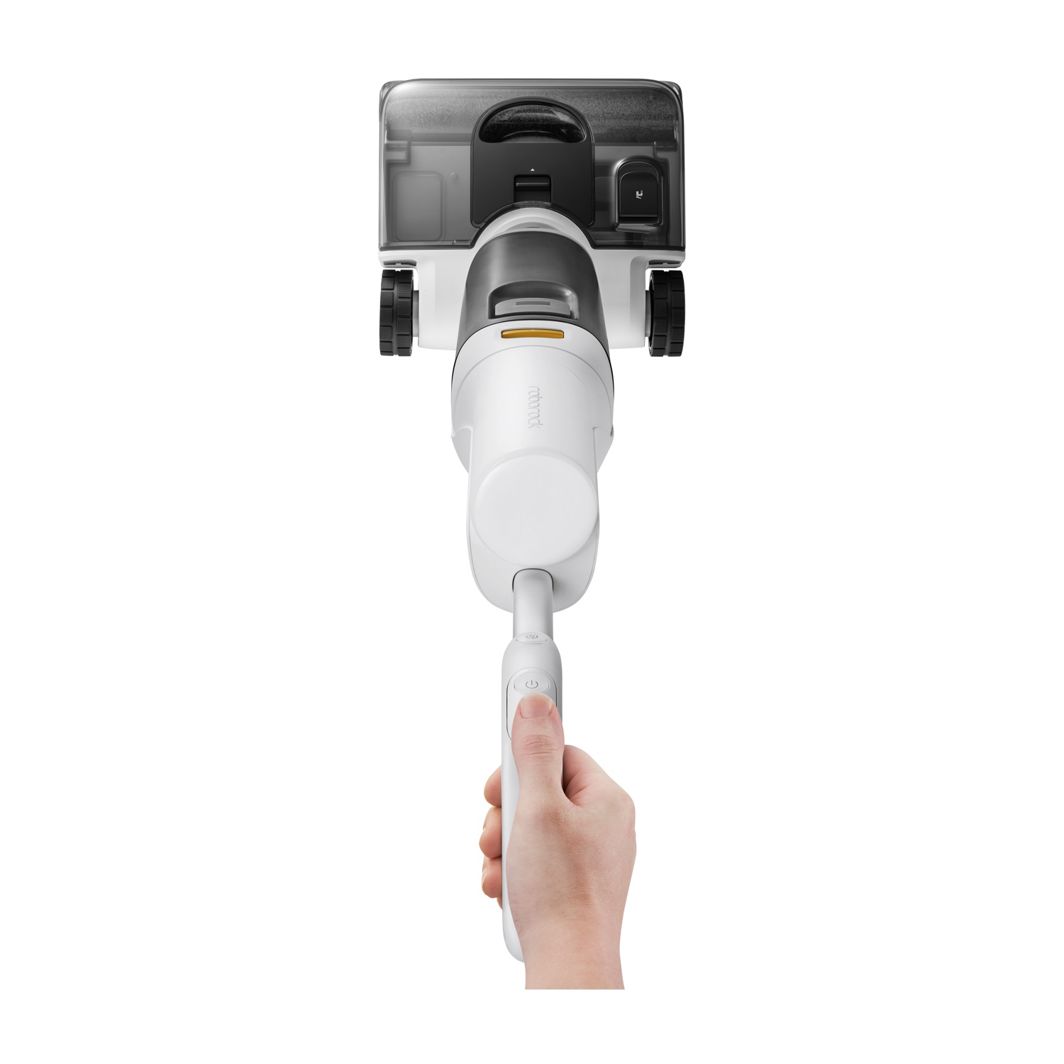 Mano che tiene manico aspirapolvere bianco, fronte con serbatoio acqua e spazzola.