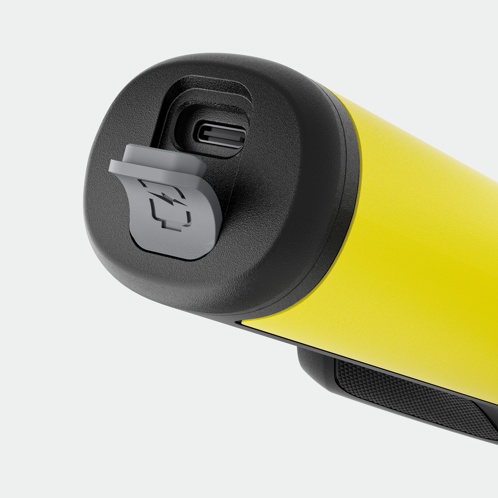 Sárga készülék közelképe fekete porttal és szürke fedéllel. USB-C látható.