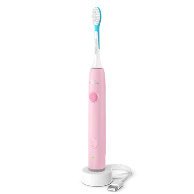 Uno spazzolino elettrico rosa con testina blu è sulla base di ricarica.