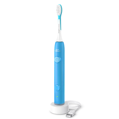Spazzolino elettrico blu con spia di ricarica su base bianca.