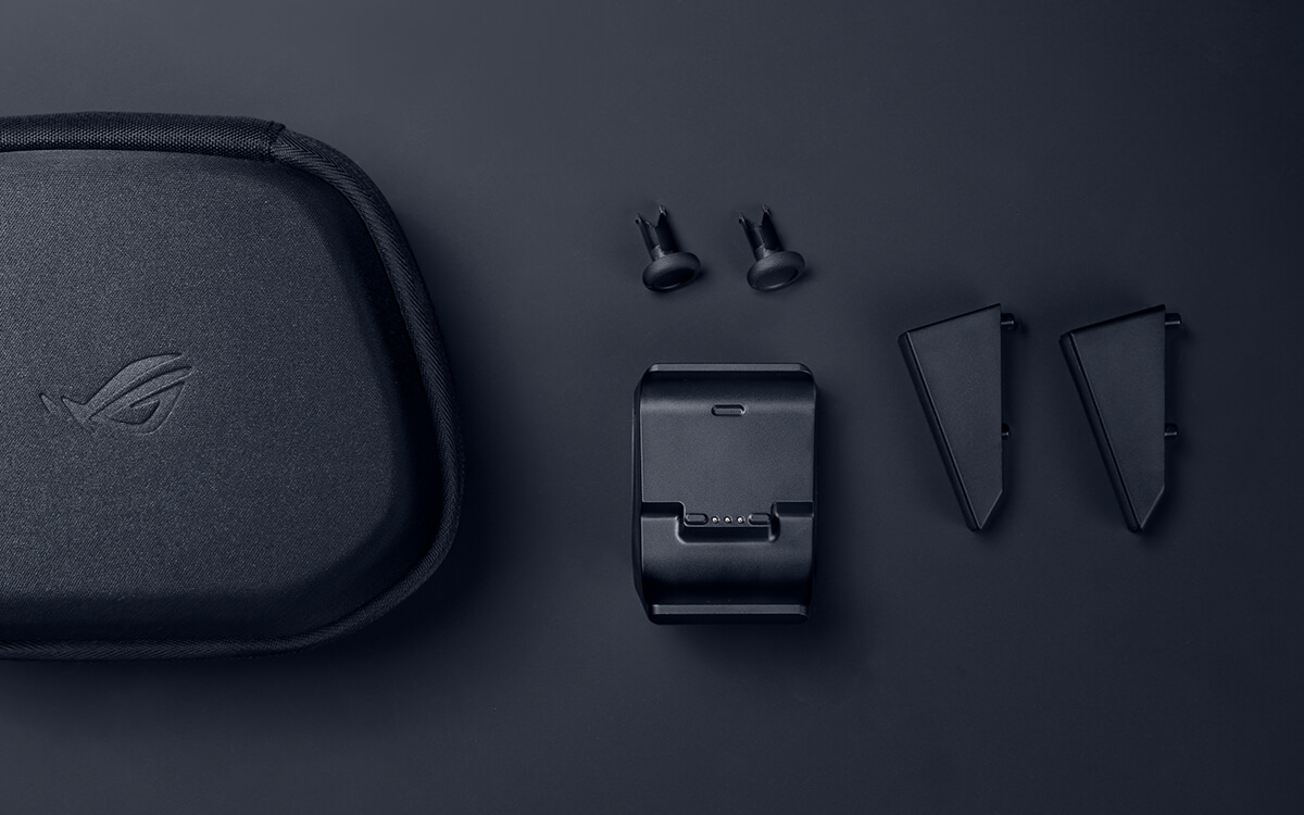 Une mallette noire avec logo ROG, station de charge et deux accessoires sur fond sombre.