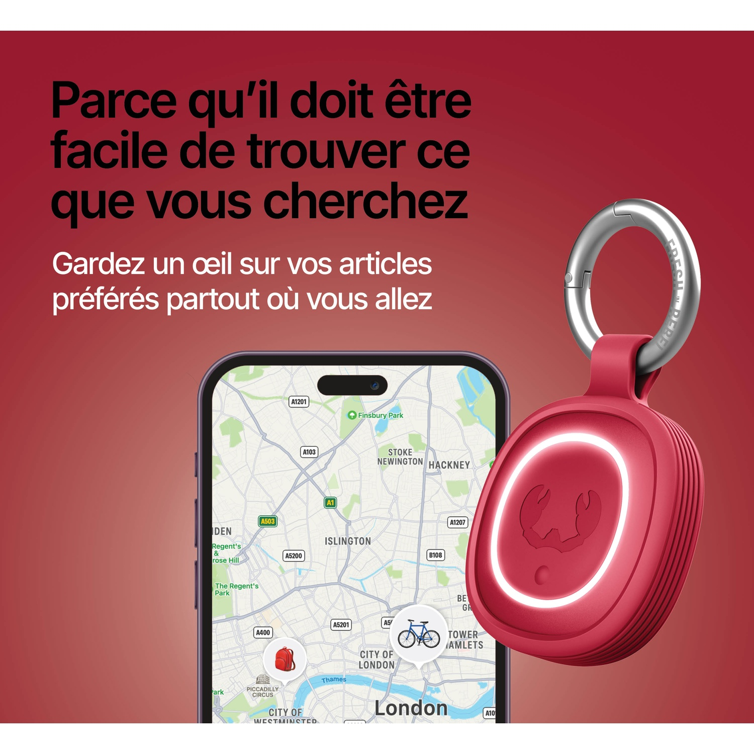Traceur rouge avec porte-clés à côté d'un smartphone affichant une carte de Londres.
