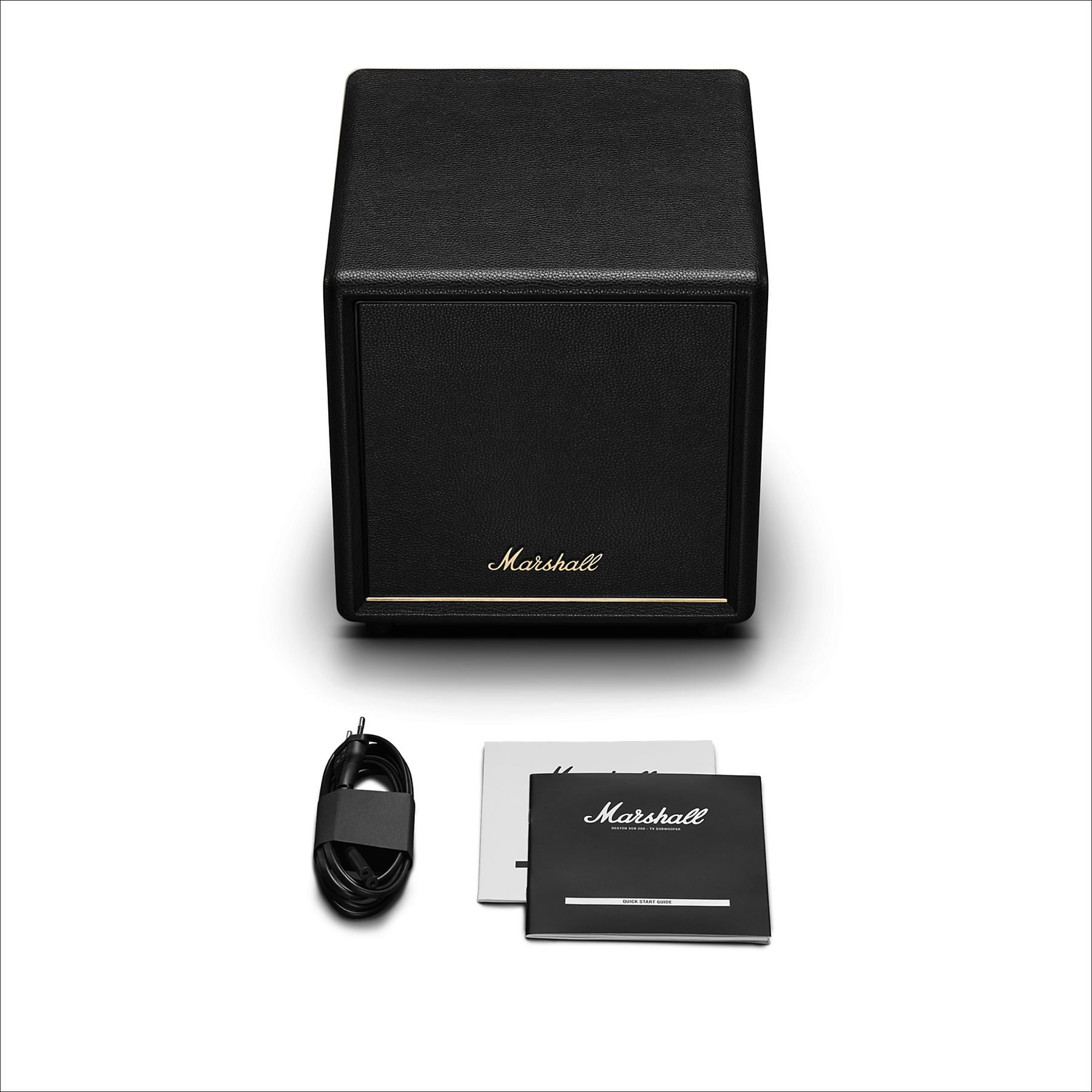 Amplificador Marshall negro con cable y manual sobre fondo blanco.