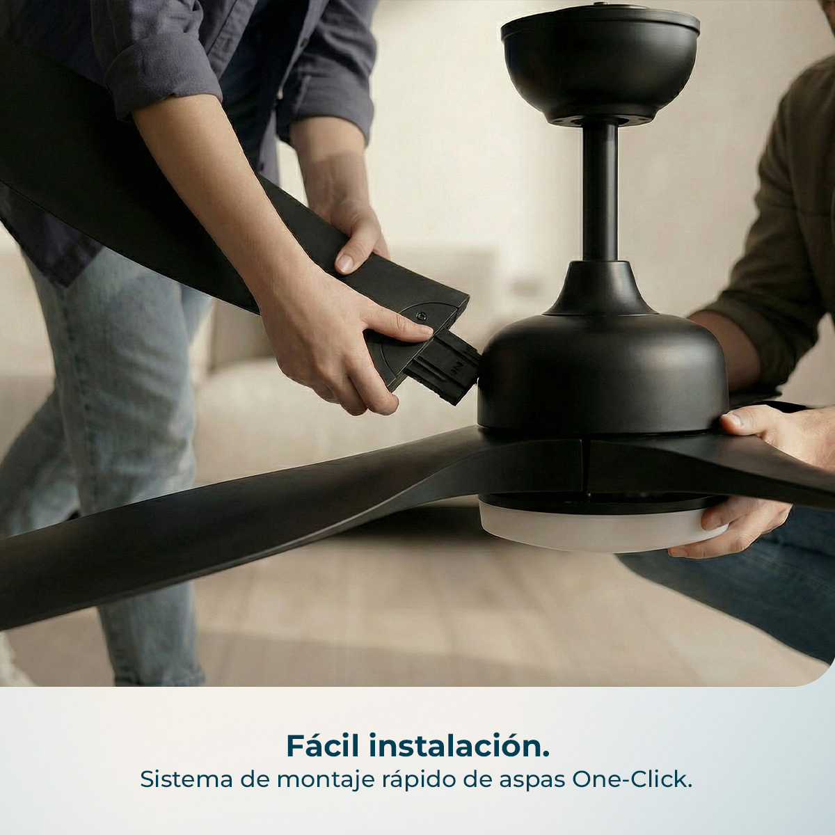 Dos personas montan un ventilador de techo negro con un accesorio de un clic.