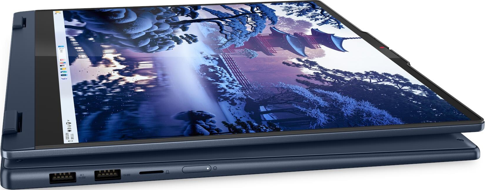 Ein geschlossenes blaues Laptop mit einem Winterwald-Bildschirmhintergrund.