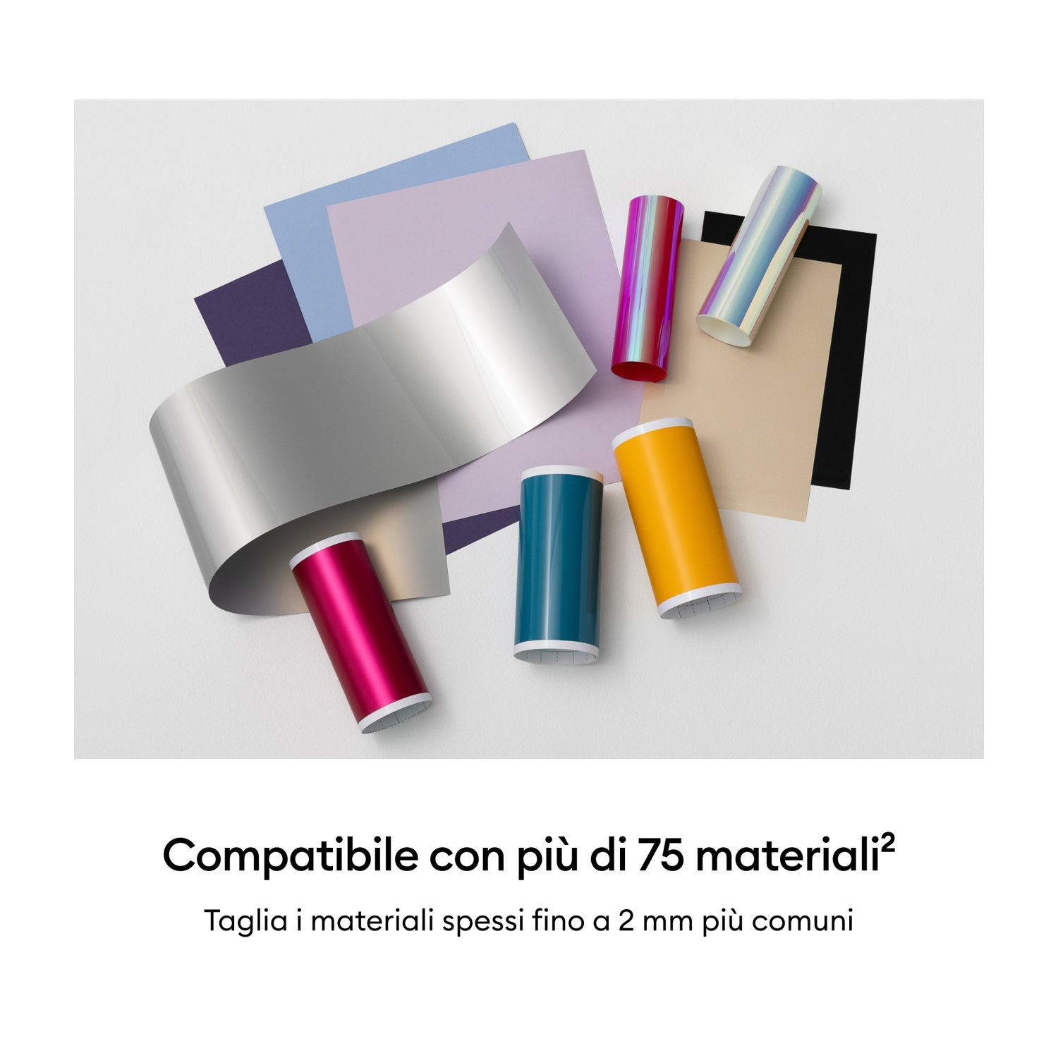 Rotoli e carta di vari colori su sfondo bianco.